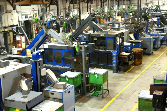 Industrial factory floor with machinery and yellow lines.