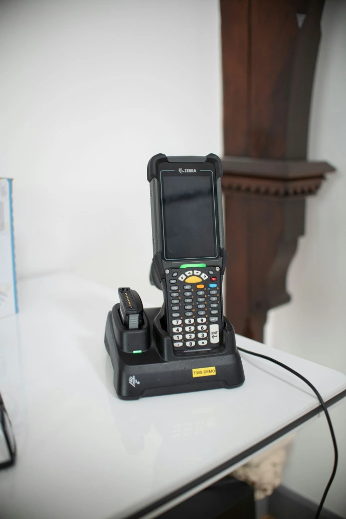 Barcode scanner device in charging dock on table